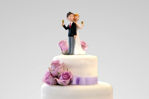 A wedding couple on top of the cake