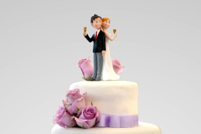 A wedding couple on top of the cake